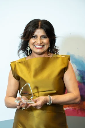Charnjit Saranna holding her Award [photograph]