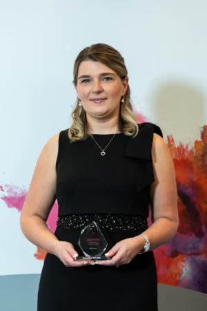 Harriet Glover holding her Award [photograph]
