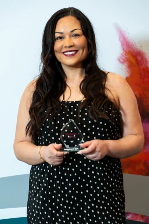 Vicky Clarke holding her Award [photograph]